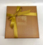 closed lid of box of 16 chocolates in a gold box
