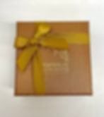 closed lid of box of 9 chocolates in a gold box